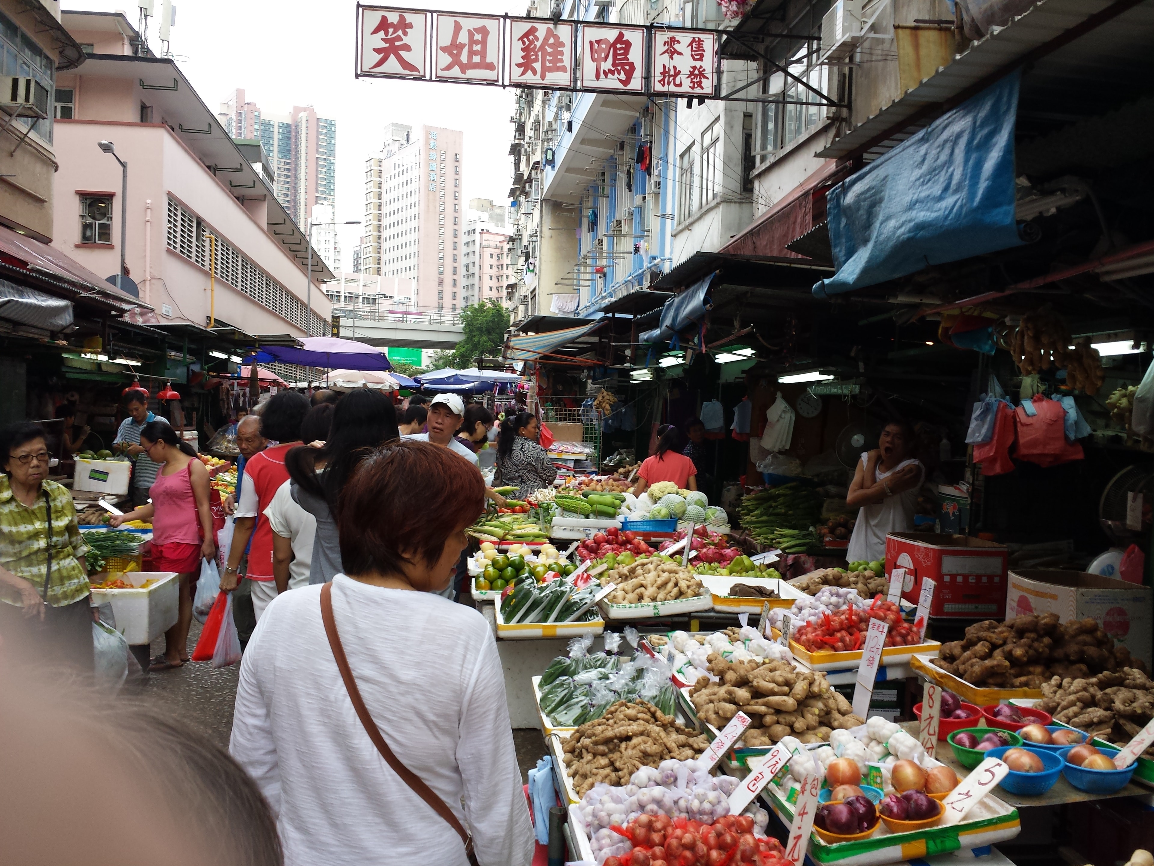 Crowded wet market with fresh vegetables and produce in Hong Kong