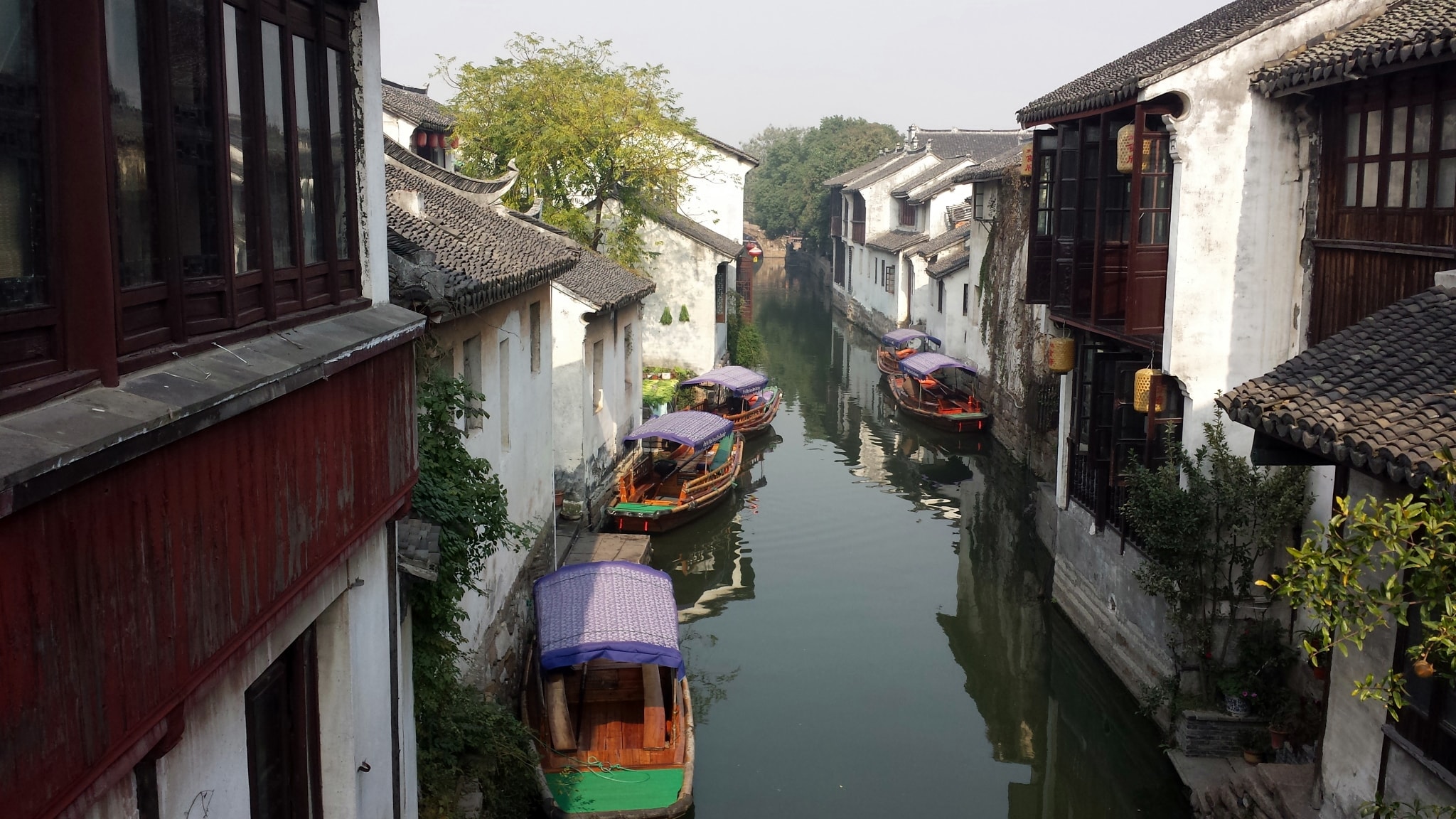 Boats on a canal lined with historic Zhouzhuang buildings