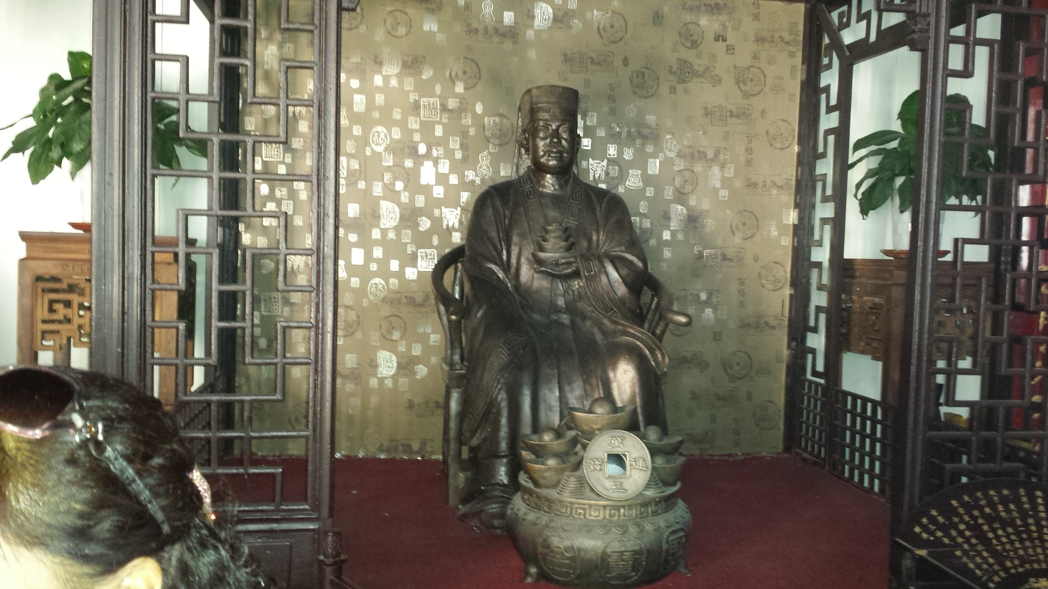 Traditional interior with a seated statue in Zhouzhuang